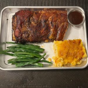 Half rack of smoked ribs with two BBQ sides from Tutta’s BBQ combo meal.